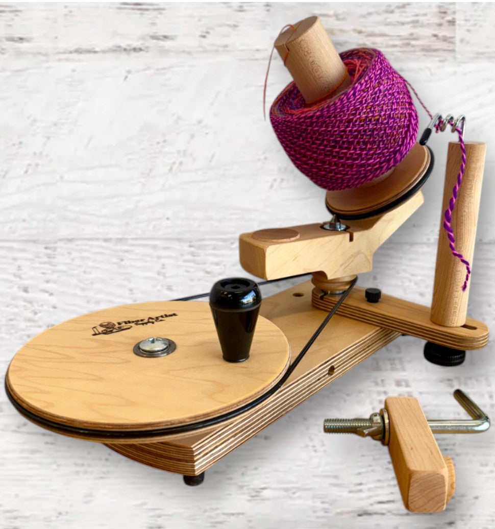 Fuzzy Goat Maple Jumbo Yarn Ball Winder made of solid wood with a purple yarn cake on a wooden table